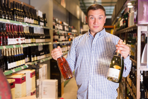 istock Man choosing wine in shop 1354927906