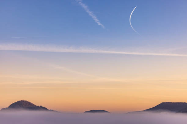 mountain peaks of the swabian alb out of the clouds in south of germany.