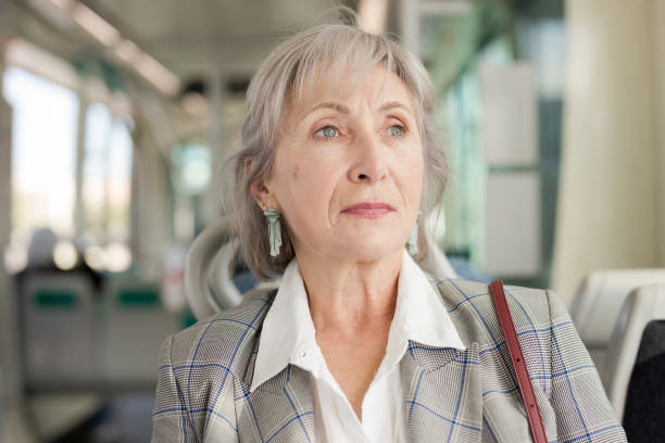 istock Senior woman in tram 1354931838