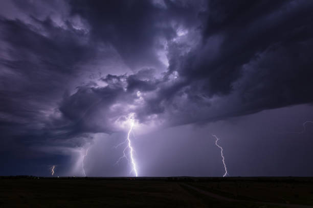 istock Stormy night sky with lightning strikes 1354932289