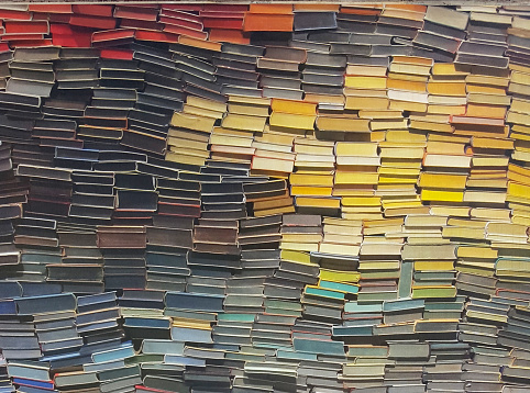 pattern of many books primarily laid  horizontal into a creative unique arrangement