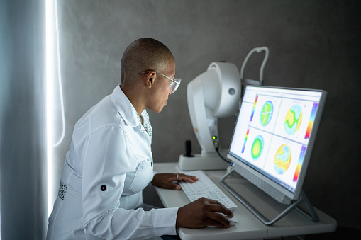 Doctor analyzing exam's results in a monitor