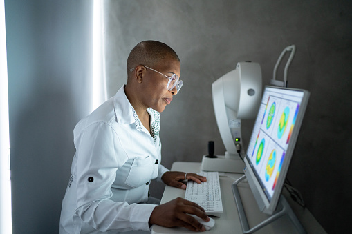 Doctor analyzing exam's results in a monitor