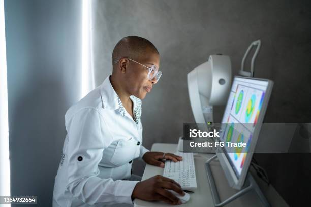 Doctor Analyzing Exams Results In A Monitor Stock Photo - Download Image Now - Doctor, Computer, Laboratory