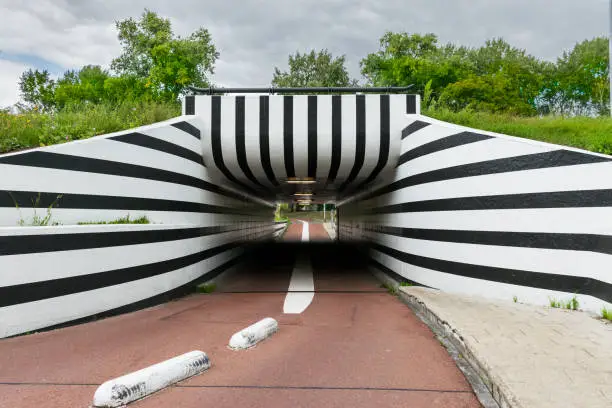 bicycle path going through a tunnel with black and white pattern in Eindhoven in the Netherlands.