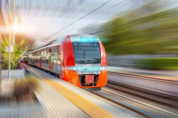 istock Railway station and passing suburban train with motion blur effect. Convenience concept of passenger transportation urban infrastructure. 1354933544