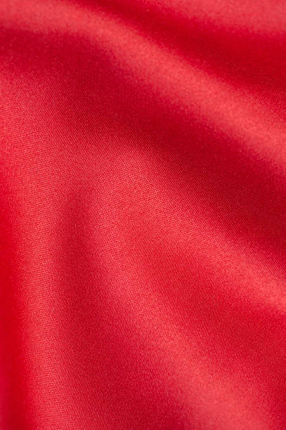 istock Red satin fabric background. Copy space. Vertical photo 1354934981
