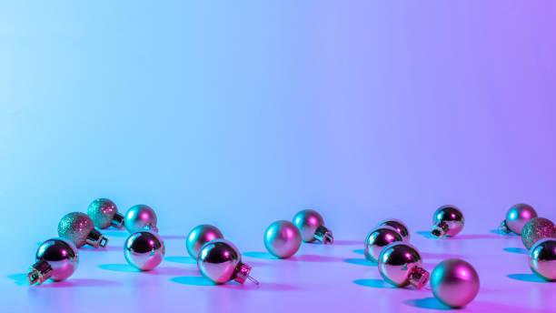 istock Christmas balls pattern neon background. Xmas bauble on abstract holiday winter gradient backdrop. Happy new year copy space. 1354935046
