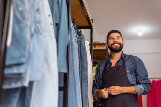 istock Confident seller in clothing store. 1354936851
