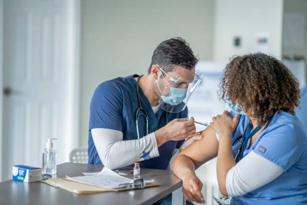 istock Giving a Colleague a Vaccine 1354938057
