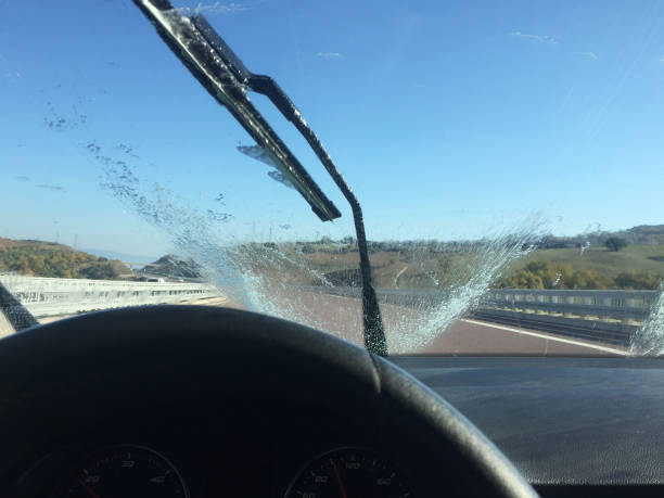 istock Washing the car windscreen with windshield wiper 1354940231