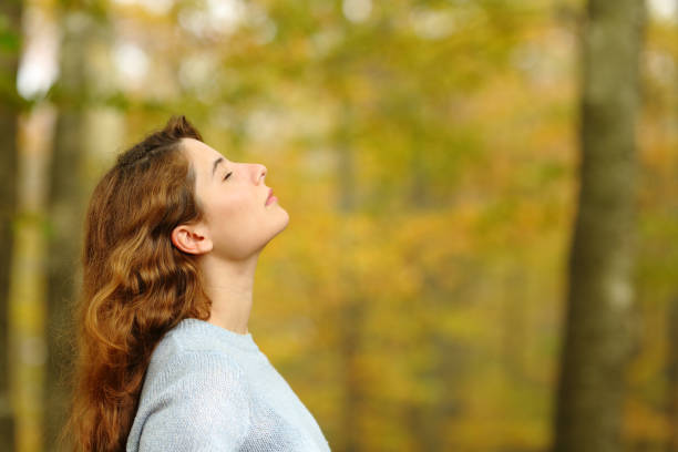istock Woman profile breathing fresh air in a park 1354940237