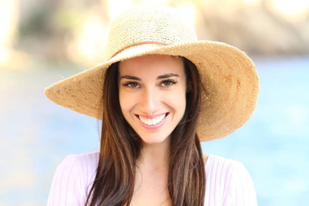 istock Happy woman on the beach looking at camera smiling 1354942826