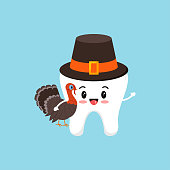 istock Thanksgiving tooth boy in pilgrim hat with turkey in hand. 1354943239