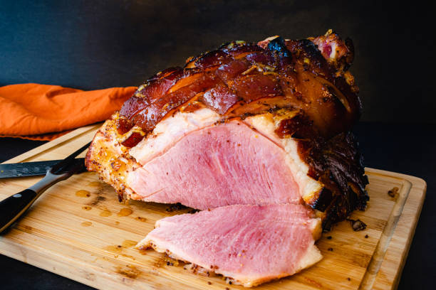 istock Bourbon Orange Glazed Ham on a Bamboo Carving Board 1354944416