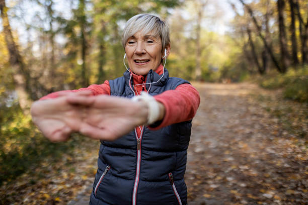 istock Senior woman exercise in public park 1354944740