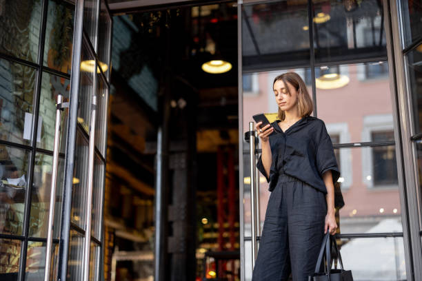 istock Woman with phone near pub 1354944791