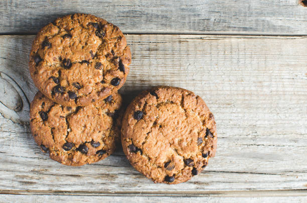 istock Cookies with chocolate on a wooden table. 1354947621