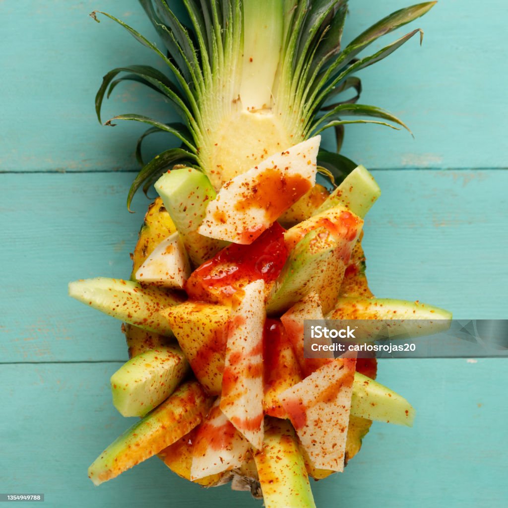 Cucumber, jicama and pineapple with chili powder and chamoy sauce on turquoise background. Mexican snack Fresh cucumber, jicama and pineapple with chili powder and chamoy sauce on turquoise background. Mexican snack Backgrounds Stock Photo Cucumber, jicama and pineapple with chili powder and chamoy sauce on turquoise background. Mexican snack Fresh cucumber, jicama and pineapple with chili powder and chamoy sauce on turquoise background. Mexican snack Backgrounds Stock Photo