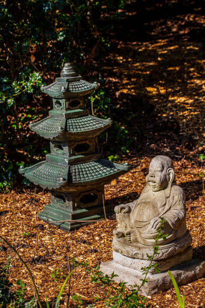 istock Happy Buddha Figure with Miniature Temple 1354951176
