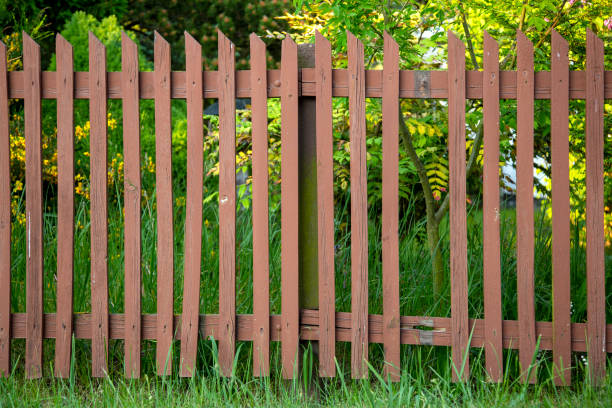 istock Wooden garden fence with a missing plank 1354954034
