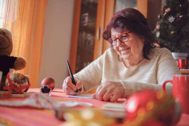 istock Lovely grandmother writing a letter 1354954322