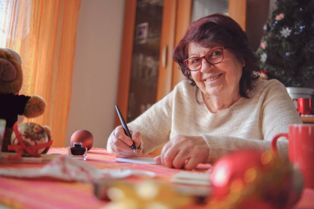 istock Lovely grandmother writing a letter 1354954324