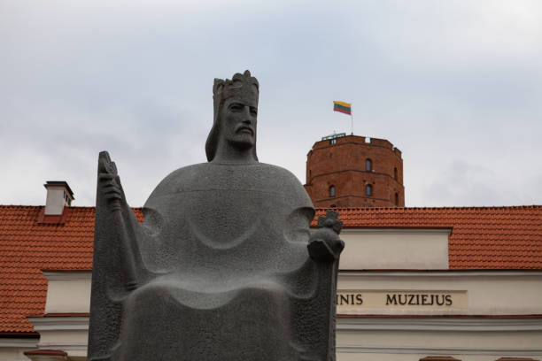 Vilnius, Lithuania - November 5, 2021: Monument of King Mindaugas in front of National Museum and Gediminas Castle. Sculptor Regimantas Midvikis, 2003.