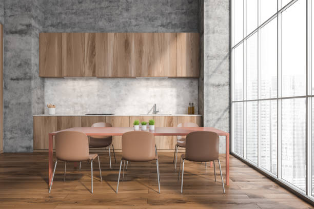 istock Minimalist wood kitchen with concrete wall and floor to ceiling windows 1354955302