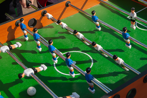 Children's table football, a game in the hands of children. Children's outdoor leisure.
