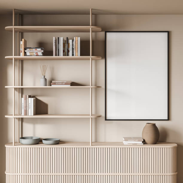 istock Empty canvas on beige wall with stylish living room shelving 1354955994