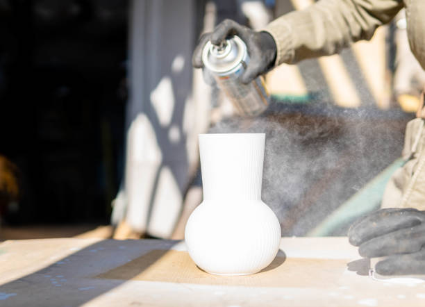 istock Spray painting a vase 1354957194