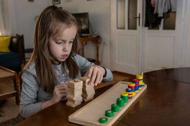 istock Girl playing with mathematical toy 1354958974