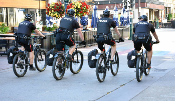 Building Exterior, Canada Local Police Officers On Bicycle Scene During Autumn Season In Calgary Alberta Canada