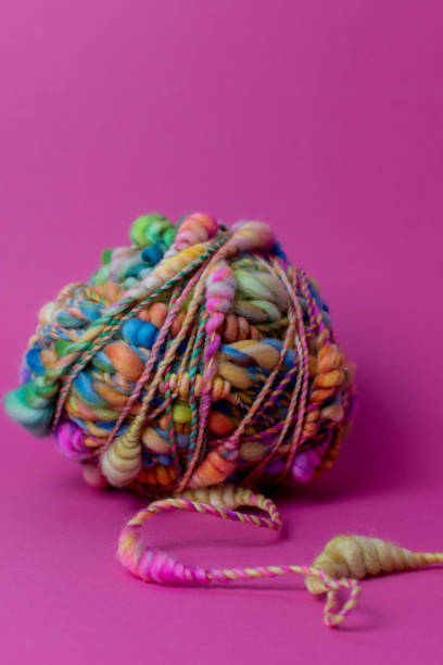 istock Knitting with colourful textured pink art yarn 1354960963