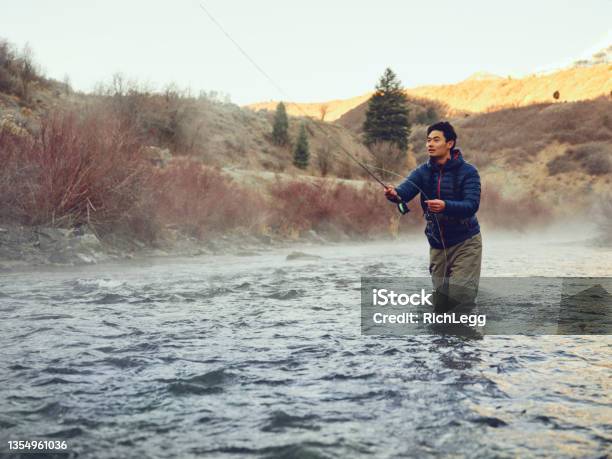 Asian Man On Provo River Fly Fishing In Utah Stock Photo - Download Image Now - Fishing, Water, Cold Temperature