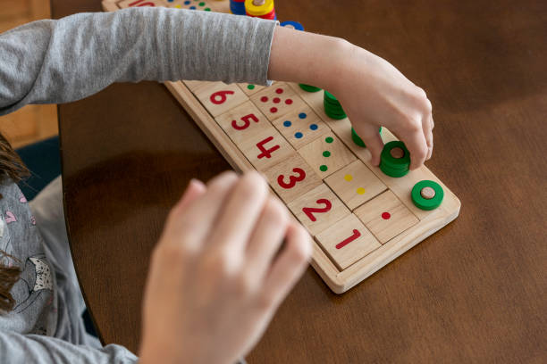istock Child playing with mathematical toy 1354962034