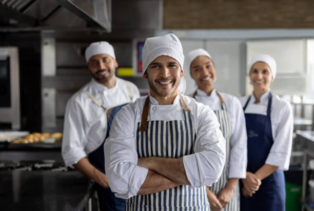 istock Happy group of bakers working at the bakery 1354962824