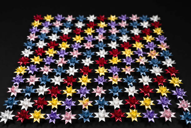 istock Folding paper stars on Black background. 1354963579
