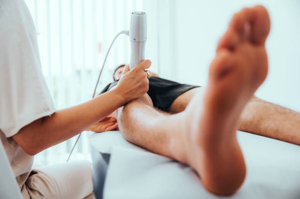 클리닉에서 초음파 스캐너를 사용하는 남성을위한 무릎 관절의 초음파 검사 - doctor human knee human leg medical exam 뉴스 사진 이미지