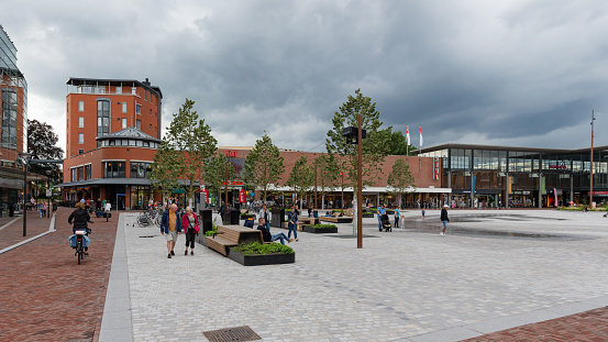 Assen, Drenthe, Netherlands, august 9th 2021, large group of people (shopping, walking, cycling, sitting, relaxing) in the city center of Assen at the Koopmansplein square shopping area - Assen was one of the first Dutch cities to receive city rights (in 1809)