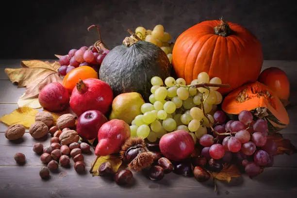 Photo of Pumpkins and autumn fruits in vintage setting, still life.