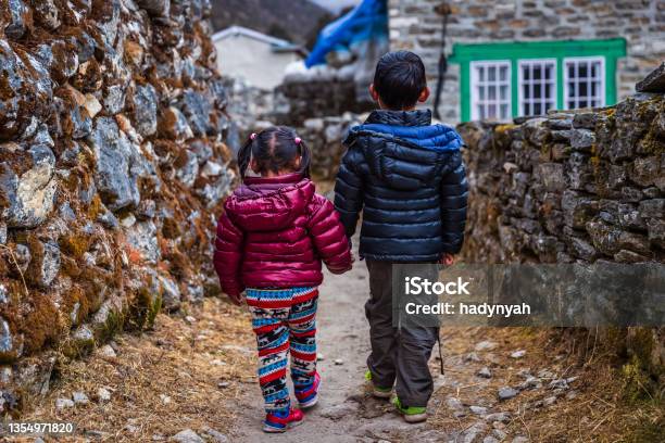 Boy And Girl Walking In A Village In Mount Everest National Park Nepal Stock Photo - Download Image Now