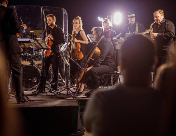 istock Musical ensemble performing live orchestra concert at night 1354974599