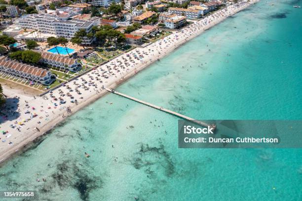Aerial Drone Photo Of The Beach Front On The Spanish Island Majorca Mallorca Spain Showing The Beach Known As Platja De Muro In The Village Of Alcúdia On A Sunny Summers Days Stock Photo - Download Image Now