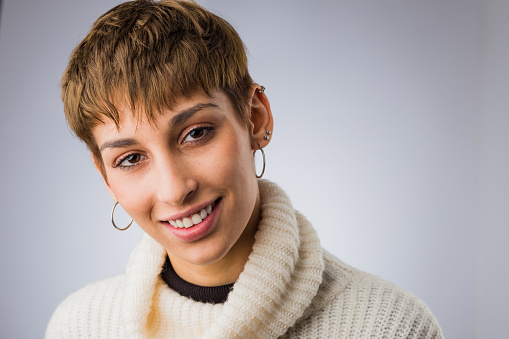an studio headshot portrait from a Latina student with fashion short hair and ambiguous hairstyling
