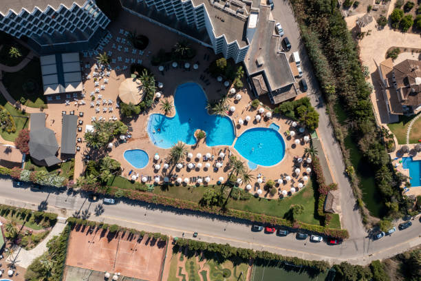 Aerial drone photo taken on the beautiful island of Majorca in Spain showing a top down view of a hotel apartment building and out door swimming pool stock photo