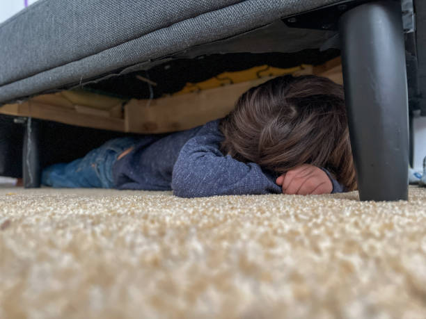 istock Sleepy Boy Fell Asleep Under the Couch 1354984058