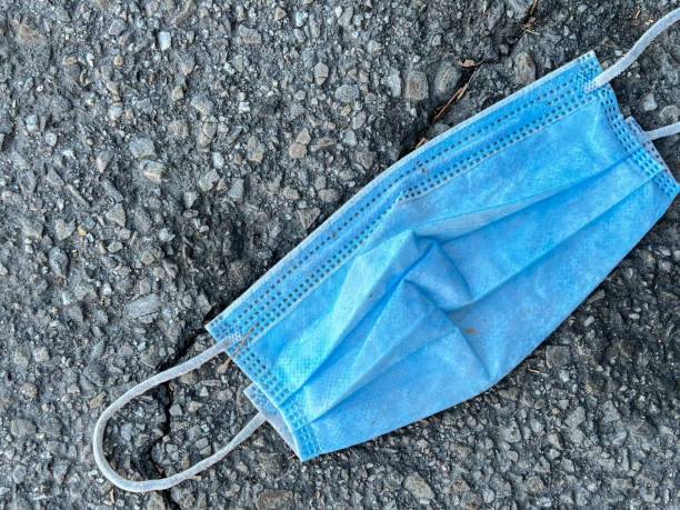 istock A Mask on the Ground After a One Time Use 1354984074
