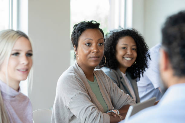 istock Diverse women working together during board room meeting 1354988444